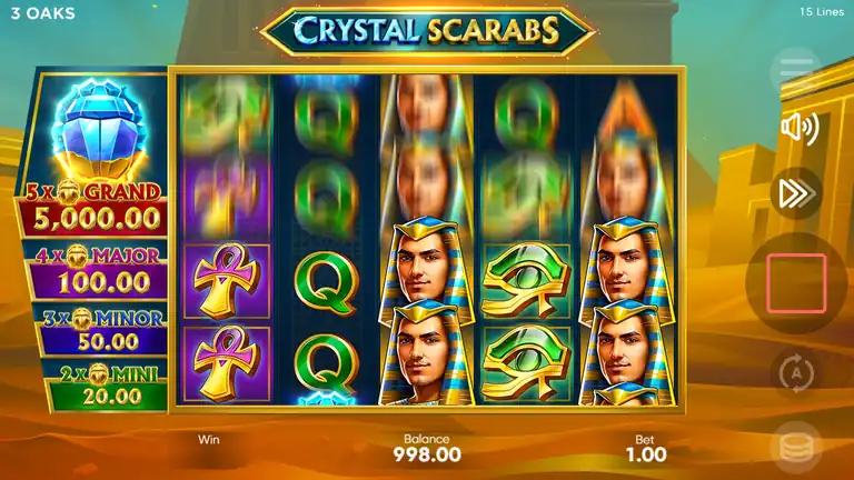 Crystal Scarabs base game showing 5x4 grid with jackpot panel on left (GRAND 5000, MAJOR 100, MINOR 50, MINI 20), Egyptian desert backdrop, balance 998.00, bet 1.00